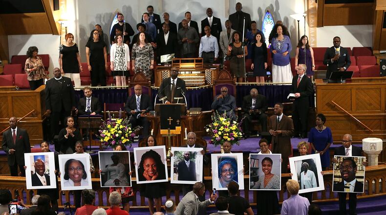 Photographs of the nine victims killed at the Emanuel AME Church in Charleston, South Carolina, are held up by congregants during a prayer vigil at the Metropolitan AME Church on June 19, 2015, in Washington, DC. (Win McNamee/Getty Images)