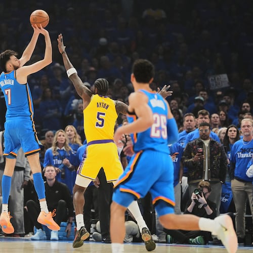 Oklahoma City Thunder center Chet Holmgren (7) shoots over Los Angeles Lakers center Deandre Ayton (5) as Ajay Mitchell (25) looks on in the first half of Game 1 in a second-round NBA basketball playoffs series Tuesday, May 5, 2026 in Oklahoma City. (AP Photo/Kyle Phillips)