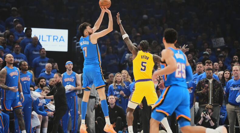 Oklahoma City Thunder center Chet Holmgren (7) shoots over Los Angeles Lakers center Deandre Ayton (5) as Ajay Mitchell (25) looks on in the first half of Game 1 in a second-round NBA basketball playoffs series Tuesday, May 5, 2026 in Oklahoma City. (AP Photo/Kyle Phillips)