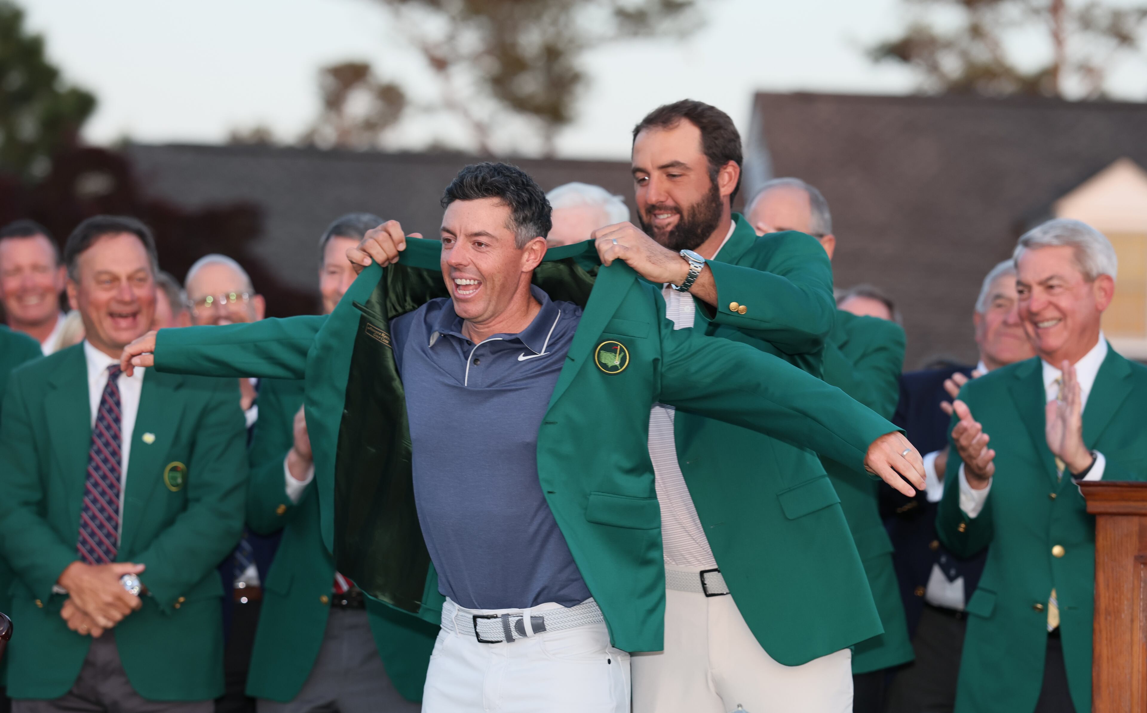 Scottie Scheffler, 2024 Masters champion, places green jacket on 2025 winner Rory McIlroy at Augusta National Golf Club, Sunday, April 13, 2025, in Augusta, Ga. (Jason Getz / AJC)