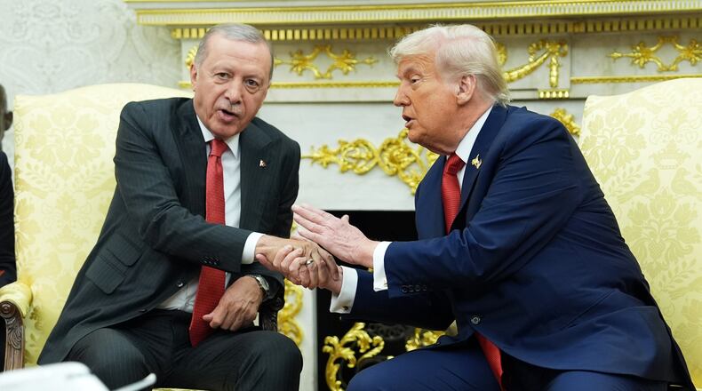 FILE - President Donald Trump, right, shakes hands with Turkish President Recep Tayyip Erdogan during a meeting in the Oval Office of the White House, Sept. 25, 2025, in Washington. (AP Photo/Evan Vucci, File)