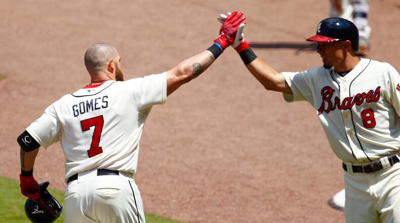 ATLANTA, GA - MAY 3: Jonny Gomes #7 of the Atlanta Braves is congratulated by teammate Jace Peterson after hitting a solo home run against the Cincinnati Reds during the third inning at Turner Field on May 3, 2015 in Atlanta, Georgia. (Photo by Kevin Liles/Getty Images)