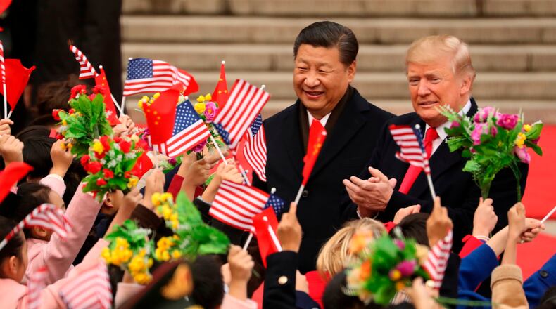 FILE - President Donald Trump and Chinese President Xi Jinping participate in a welcome ceremony at the Great Hall of the People in Beijing, China, Nov. 9, 2017. (AP Photo/Andrew Harnik, File)