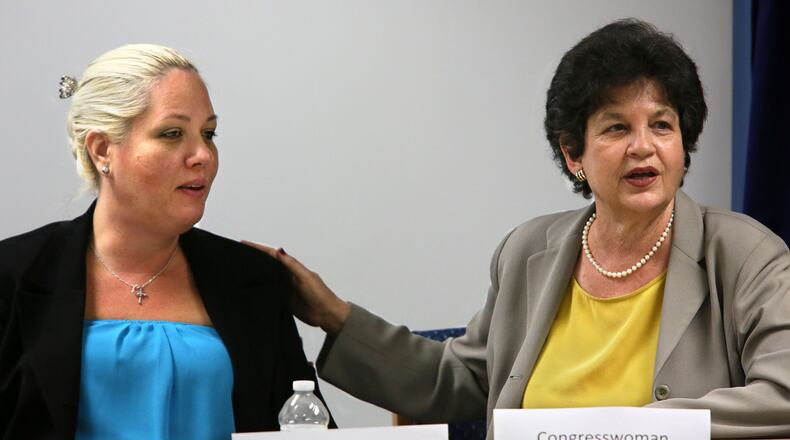 Katariina Rosenblatt, a survivor of human trafficking, sits with U.S. Rep. Lois Frankel during a field hearing on human trafficking with local and federal officials at the State Attorney's office Friday, July 12, 2013.