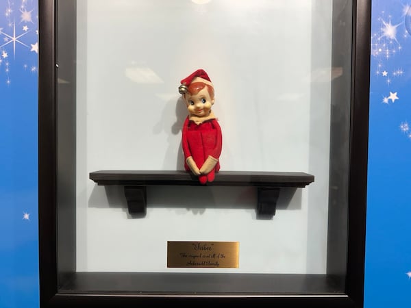 At Lumistella headquarters in Atlanta, Fisbee, the original Elf on the Shelf, is proudly displayed. Fisbee was a part of the Aebersold family's Christmas decorations. (Rodney Ho/AJC)