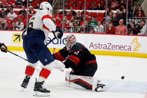 Florida Panthers' Aleksander Barkov (16) tips the puck past Carolina Hurricanes goaltender Pyotr Kochetkov (52) for a goal during the third period of Game 2 of the NHL hockey Stanley Cup Eastern Conference finals in Raleigh, N.C., Thursday, May 22, 2025. (AP Photo/Karl DeBlaker)
