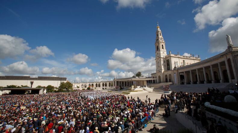 Crowds of worshippers gather during a mass with Pope Francis at the Sanctuary of Fatima  on Saturday in Portugal.