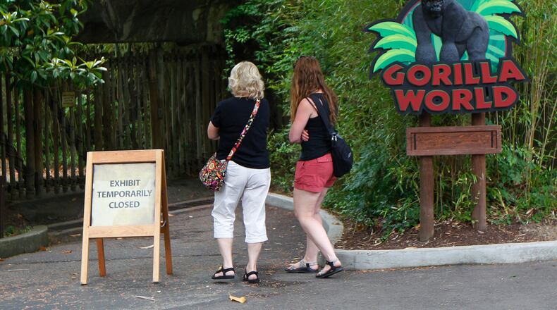 Visitors walk past the closed main entrance to the Cincinnati Zoo’s Gorilla World exhibit. (Photo by John Sommers II/Getty Images)