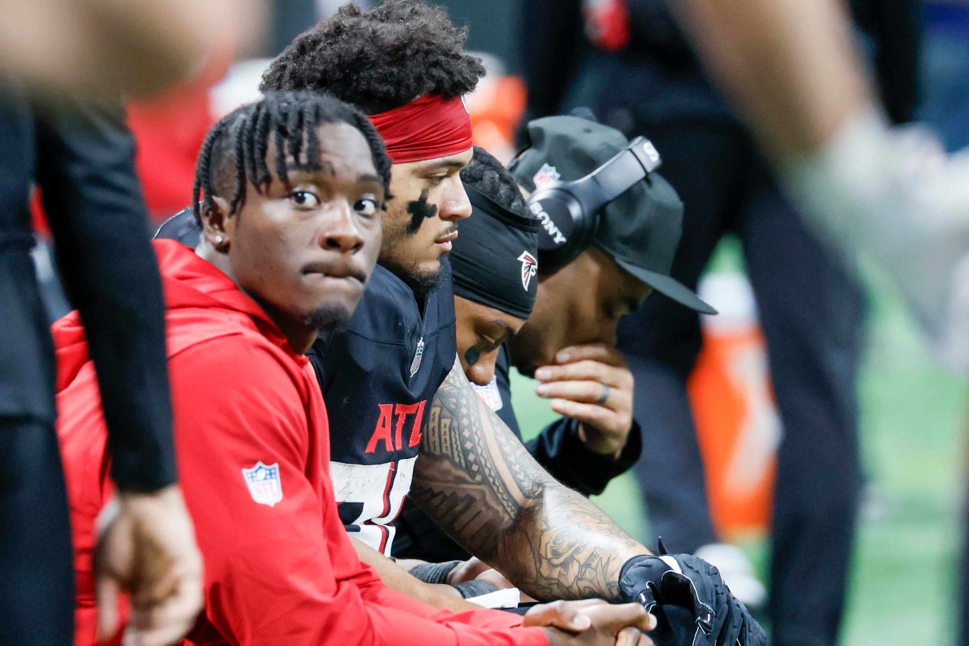 Atlanta Falcon players, including running back Tyler Allgeier (25), as their team takes a defeat 37-9 against the Seattle Seahawks at Mercedes-Benz Stadium in Atlanta on Sunday, Dec. 7, 2025. (Miguel Martinez/ AJC)