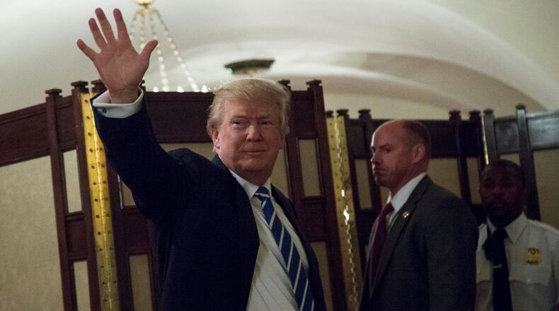 WASHINGTON, DC - MARCH 07: U.S. President Donald Trump waves in a corridor of the White House after greeting visitors, on March 7, 2017 in Washington, DC . (Photo by Aude Guerrucci-Pool/Getty Images)