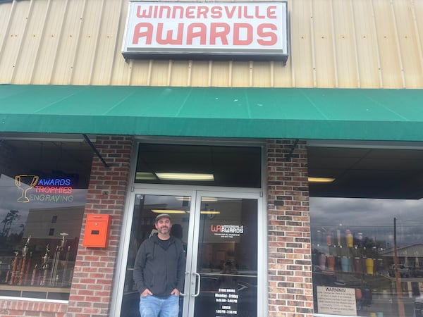 Winnersville Awards owner Raymond Scollin built the massive trophy for the annual Winnersville Classic between Valdosta and Lowndes. (Jack Leo/AJC)