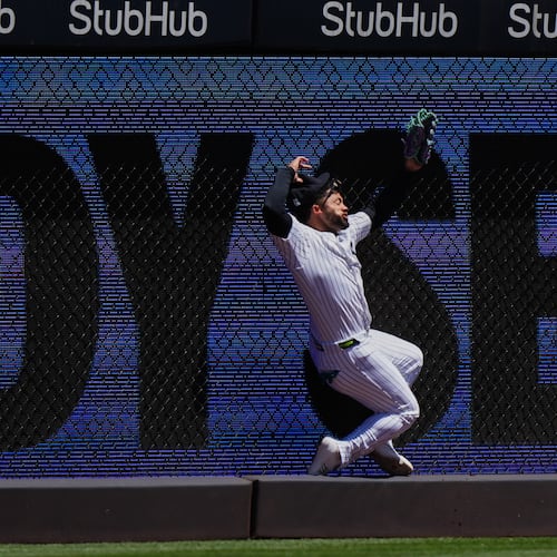 New York Yankees' Jasson Domínguez is injured while catching a ball hit by Texas Rangers' Brandon Nimmo for an out during the first inning of a baseball game Thursday, May 7, 2026, in New York. (AP Photo/Frank Franklin II)