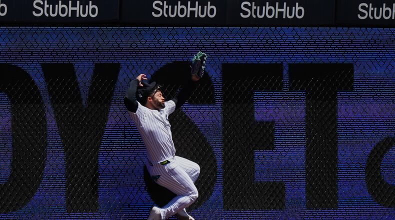 New York Yankees' Jasson Domínguez is injured while catching a ball hit by Texas Rangers' Brandon Nimmo for an out during the first inning of a baseball game Thursday, May 7, 2026, in New York. (AP Photo/Frank Franklin II)