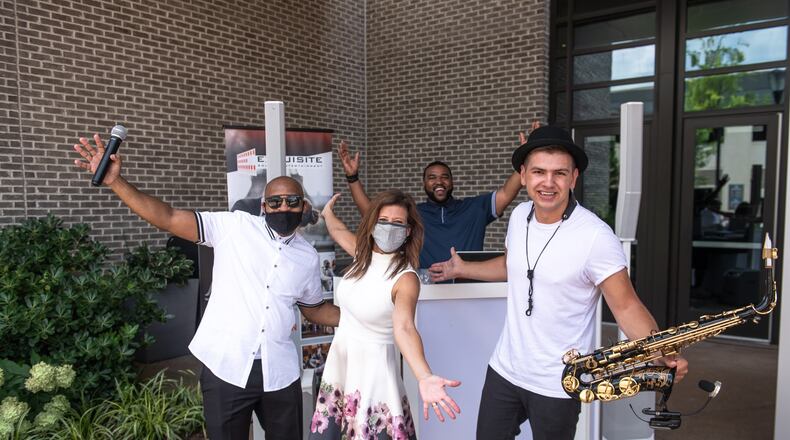 Shelly Danz, a musician and DJ are outside Hotel Avalon in July where they're ready to greet engaged couples driving up for the Atlanta Wedding Extravaganza's curbside event.