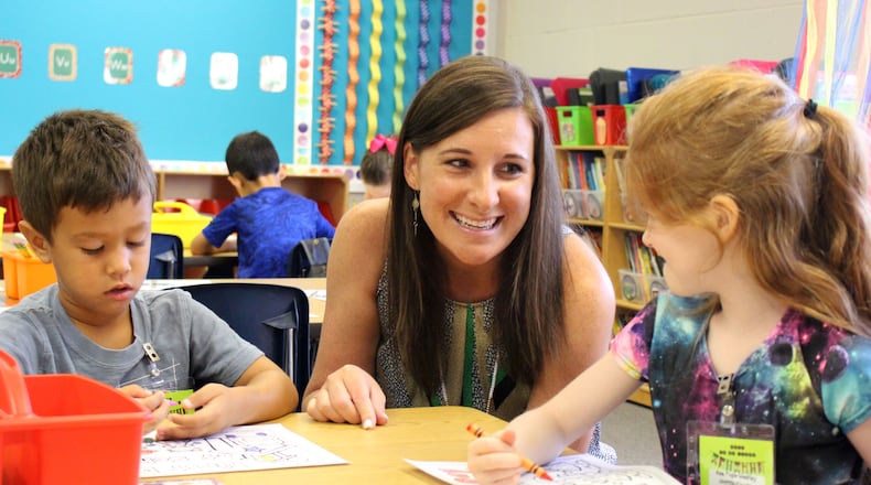 8/6/18 - Suwanee - Kerri Griffin, a kindergarten teacher at Level Creek Elementary School, talks to her students, Ana Fogle-Weekley and Owen DeGeorge, during the first day of school at Level Creek Elementary School on Monday, August 6. Griffin teaches one of the dual language immersion classes. Jenna Eason / Jenna.Eason@coxinc.com