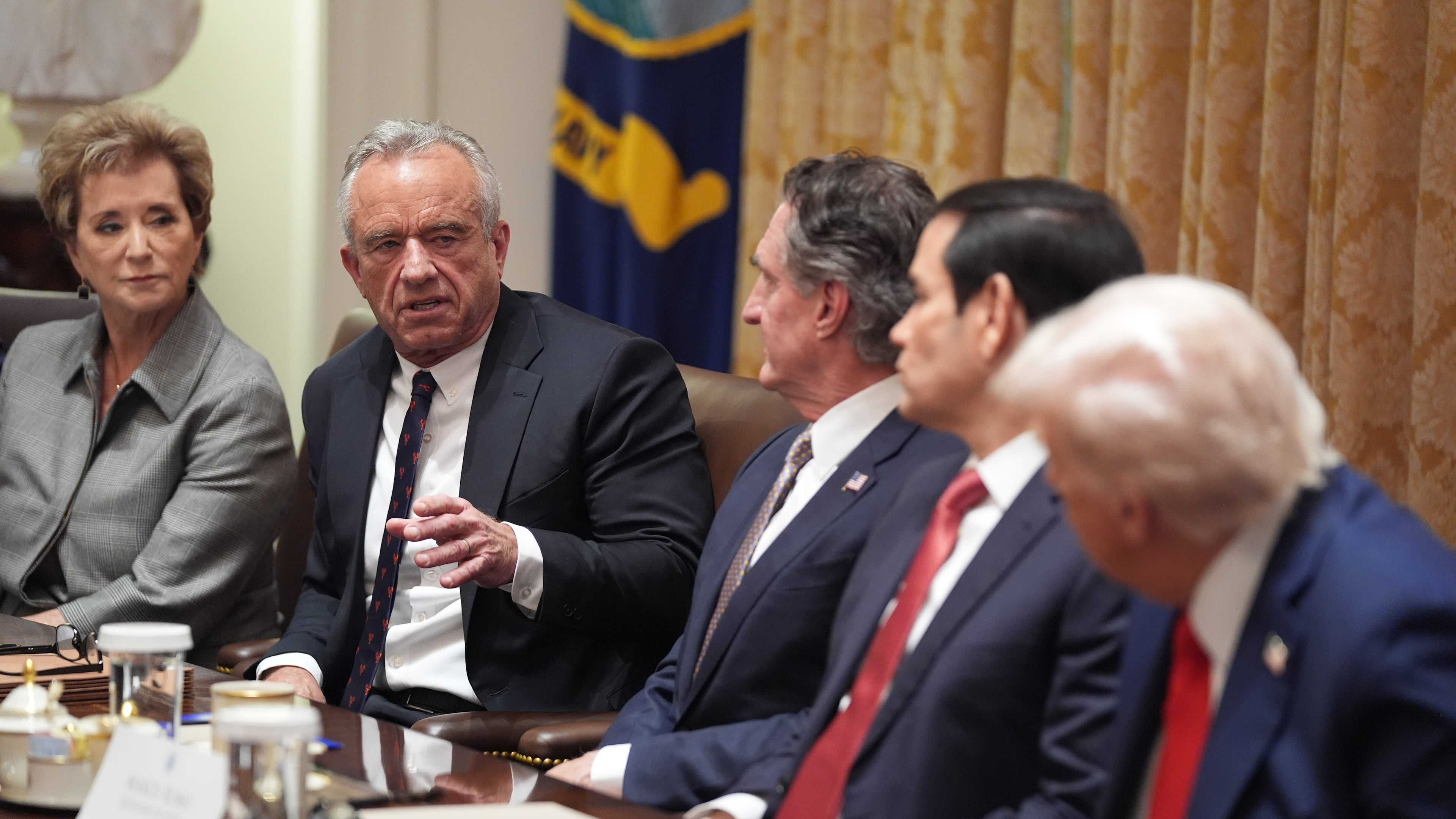Human Services Secretary Robert F. Kennedy, Jr., speaks as President Donald Trump holds a cabinet meeting at the White House, Thursday, Oct. 9, 2025, in Washington. From left, Education Secretary Linda McMahon, Kennedy, Interior Secretary Doug Burgum, Secretary of State Marco Rubio and President Donald Trump, look on. (AP Photo/Evan Vucci)