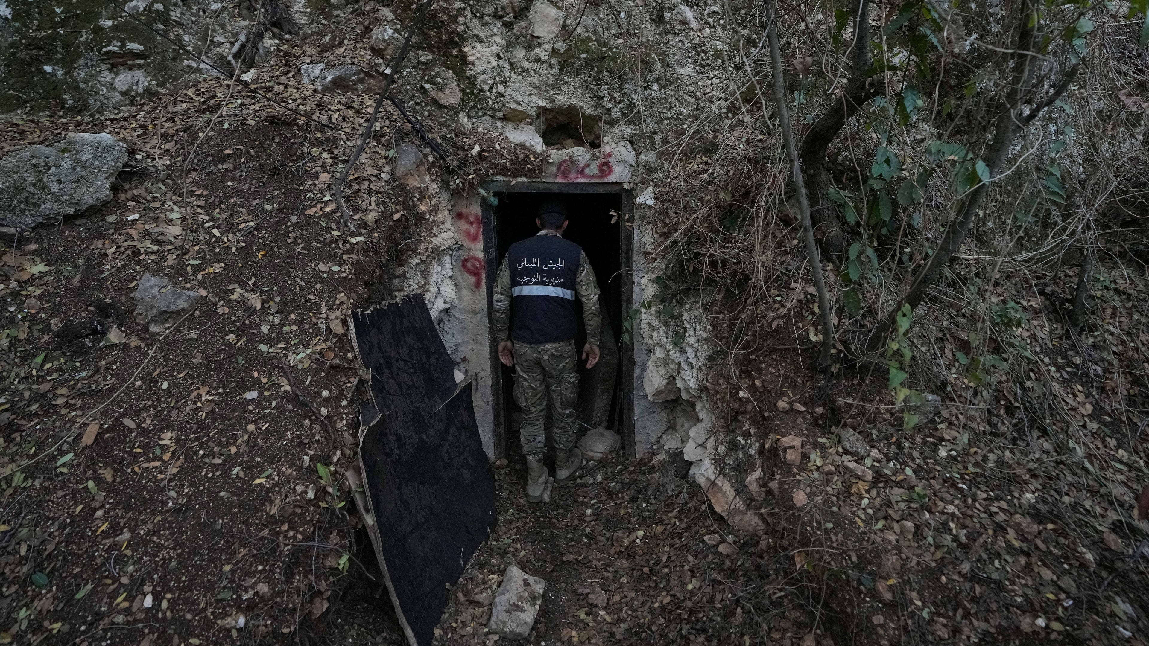 A Lebanese army soldier stands at the entrance of a tunnel dug into a mountain that was used by Hezbollah militants as a clinic and storage facility near the Lebanese-Israeli border in the Zibqin Valley, southern Lebanon, Friday, Nov. 28, 2025. (AP Photo/Bilal Hussein)