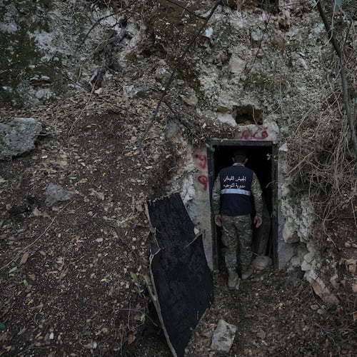 A Lebanese army soldier stands at the entrance of a tunnel dug into a mountain that was used by Hezbollah militants as a clinic and storage facility near the Lebanese-Israeli border in the Zibqin Valley, southern Lebanon, Friday, Nov. 28, 2025. (AP Photo/Bilal Hussein)