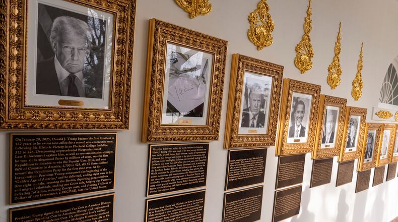 New plaques of explanatory text have been placed underneath presidential portraits on the Colonnade at the White House, Wednesday, Dec. 17, 2025, in Washington. (AP Photo/Alex Brandon)