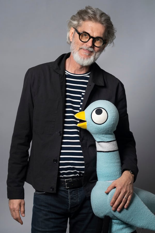 Author Mo Willems poses with The Pigeon, a character in his children's books, on April 22, 2025, in New York. (AP Photo/Gary Gerard Hamilton)