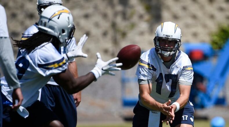 Los Angeles Chargers quarterback Philip Rivers (13) hands off to Melvin Gordon (28) during an NFL football practice Tuesday, June 13, 2017, in San Diego. (AP Photo/Denis Poroy)