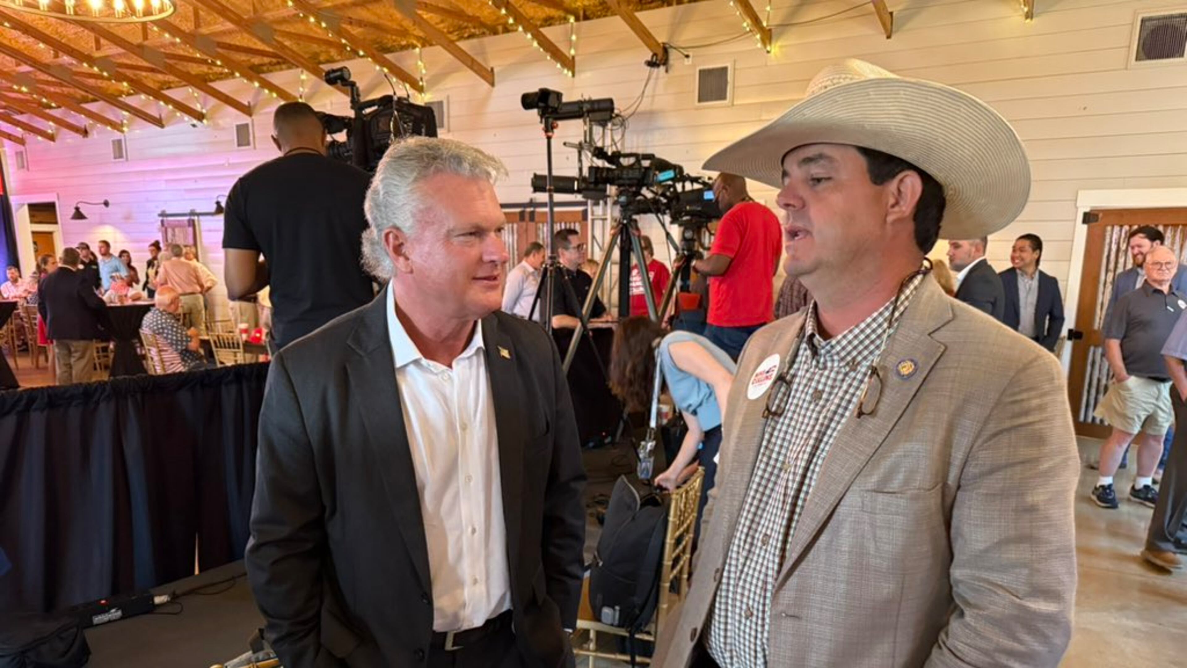 U.S. Rep. Mike Collins (left) chatted with state Sen. Sam Watson, R-Moultrie, at a campaign event in Jackson on Tuesday.