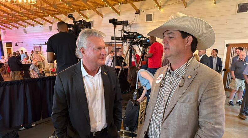 U.S. Rep. Mike Collins (left) chatted with state Sen. Sam Watson, R-Moultrie, at a campaign event in Jackson on Tuesday.