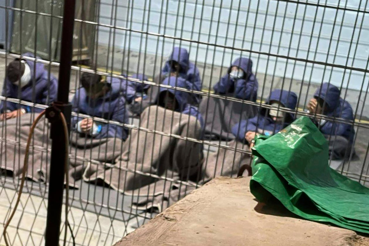This 2024 photo provided by Breaking The Silence, a whistleblower group of former Israeli soldiers, shows prisoners with their hands and legs restrained in the yard at the Sde Teiman military prison in southern Israel. (Breaking The Silence via AP)