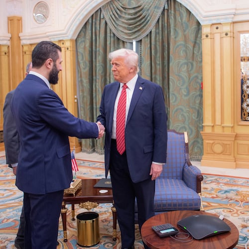 FILE - In this photo provided by the Saudi Royal Palace, Syria's interim President Ahmad al-Sharaa, left, shakes hands with U.S. President Donald Trump in Riyadh, Saudi Arabia, Wednesday, May 14, 2025. At foreground right is Saudi Crown Prince Mohammed bin Salman. (Bandar Aljaloud/Saudi Royal Palace via AP, File)