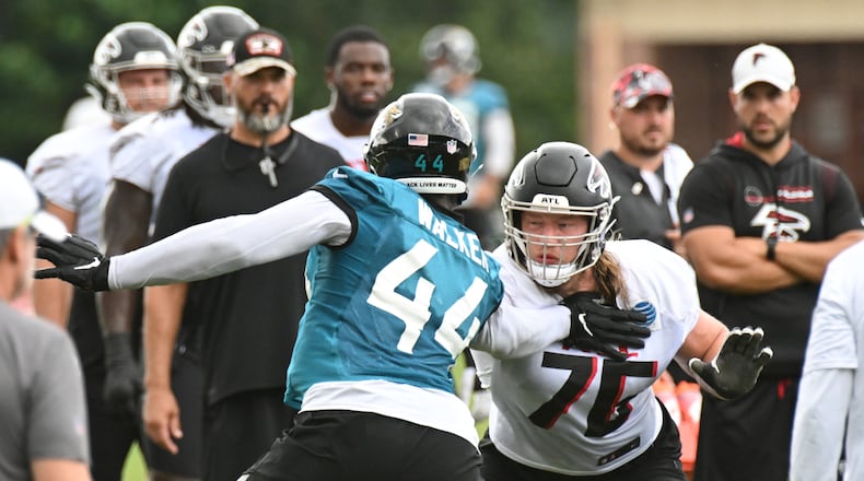 Falcons right tackle Kaleb McGary (76) practices Jaguars linebacker Travon Walker during a joint practice Aug. 25 in Flowery Branch. McGary was missing during the open media period as the Falcons returned to practice Monday after their exhibition finale. (Hyosub Shin / Hyosub.Shin@ajc.com)