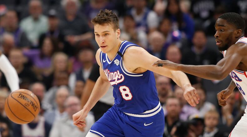 Sacramento guard Bogdan Bogdanovic (left) and Philadelphia guard Shake Milton scramble for the ball during the first quarter Thursday, March 5, 2020, in Sacramento, Calif. (Rich Pedroncelli/AP)