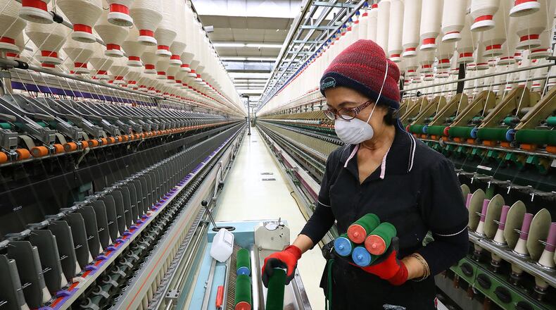 Asmarajati Djain works cleaning automated and faster specialty yawn spinning machines at Buhler Quality Yarns Corporation in Jefferson, Ga. on Monday, March 11, 2019. Curtis Compton/ccompton@ajc.com