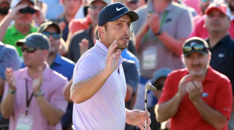 Masters leader Francesco Molinari waves to the patrons after his bunker shot to the 18th green on his way to save par and finish at 13-under at Augusta National Golf Club on Saturday, April 13, 2019, in Augusta. Curtis Compton/ccompton@ajc.com