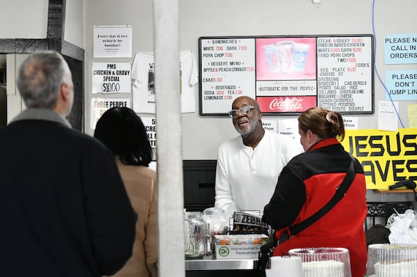 Dexter Weaver (background) helps lunch customers earlier this month at Weaver D’s Delicious Fine Foods in Athens. Weaver, 70, says he's been cooking for people since he was a kid. (Hyosub Shin/AJC)