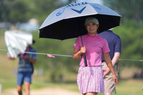 Yui Kawamoto, of Japan, uses an umbrella for the sun during the second round of the Women's PGA Championship golf tournament Friday, June 20, 2025, in Frisco, Texas. (AP Photo/LM Otero)