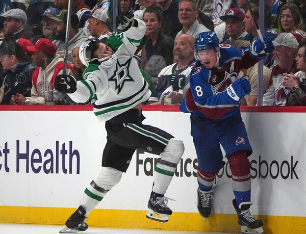 Dallas Stars left wing Mason Marchment, left, reacts after taking a check from Colorado Avalanche defenseman Cale Makar in the second period of Game 3 of an NHL hockey first-round playoff series Wednesday, April 23, 2025, in Denver. (AP Photo/David Zalubowski)