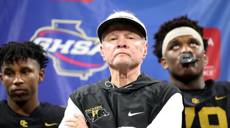 Then-Colquitt County coach Rush Propst receives the runner-up trophy against Milton in the 2018 state championship. (Jason Getz/AJC 2018)