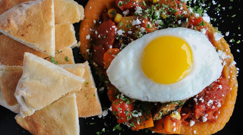 Shakashuka -- stewed peppers, tomato, okra, jalapenos, corn, sweet potato, feta, fried egg and flat bread at Dish Dive in Kirkwood. Read more about Dish Dive here. (Beckysteinphotography.com))