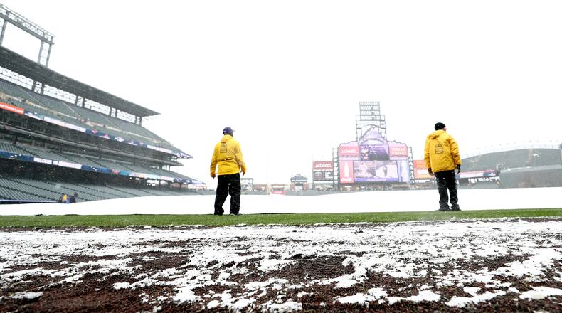 Snow blankets the field before the Colorado Rockies home opener against the Atlanta Braves at Coors Field on April 6, 2018 in Denver, Colorado.  (Photo by Matthew Stockman/Getty Images)