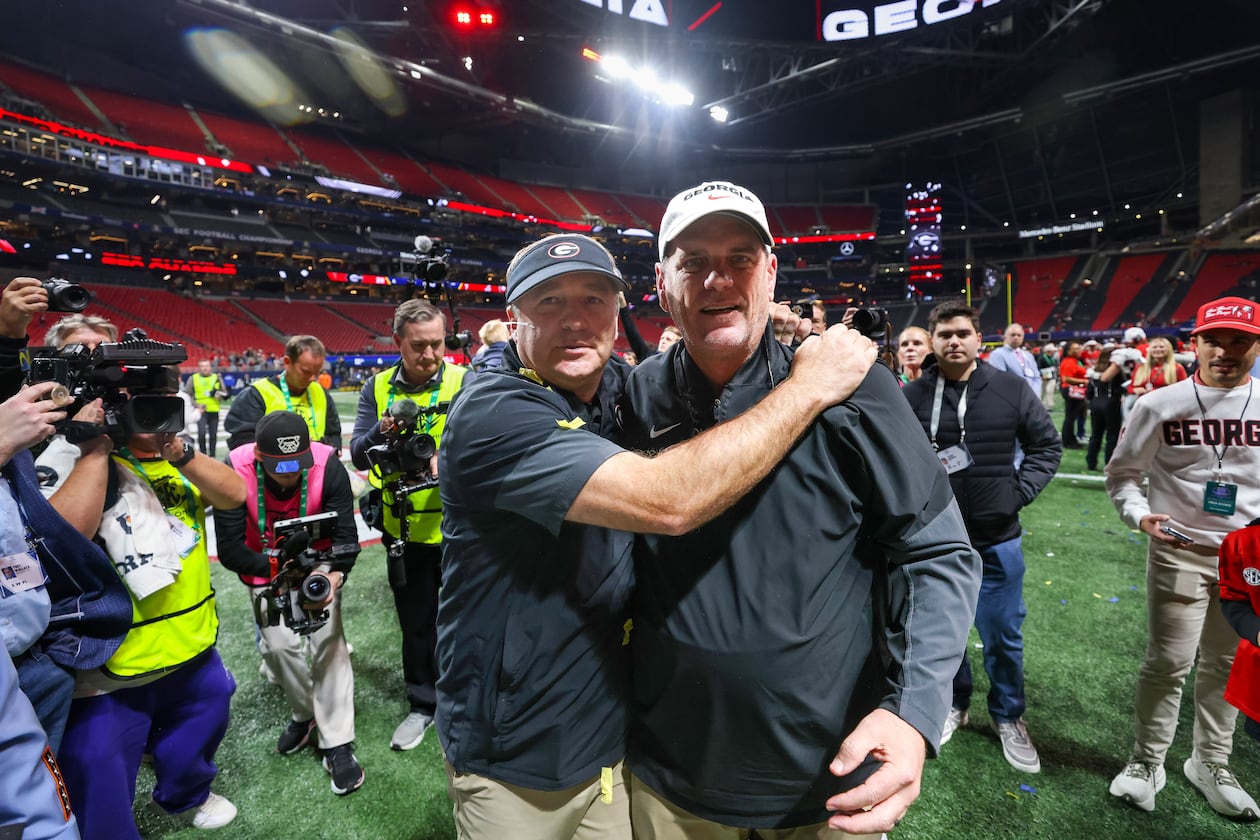 Georgia head coach Kirby Smart (left) celebrates with offensive coordinator Mike Bobo after a 28-7 victory over Alabama in the SEC Championship game at Mercedes-Benz Stadium, Saturday, Dec. 6, 2025, in Atlanta. (Jason Getz/AJC)