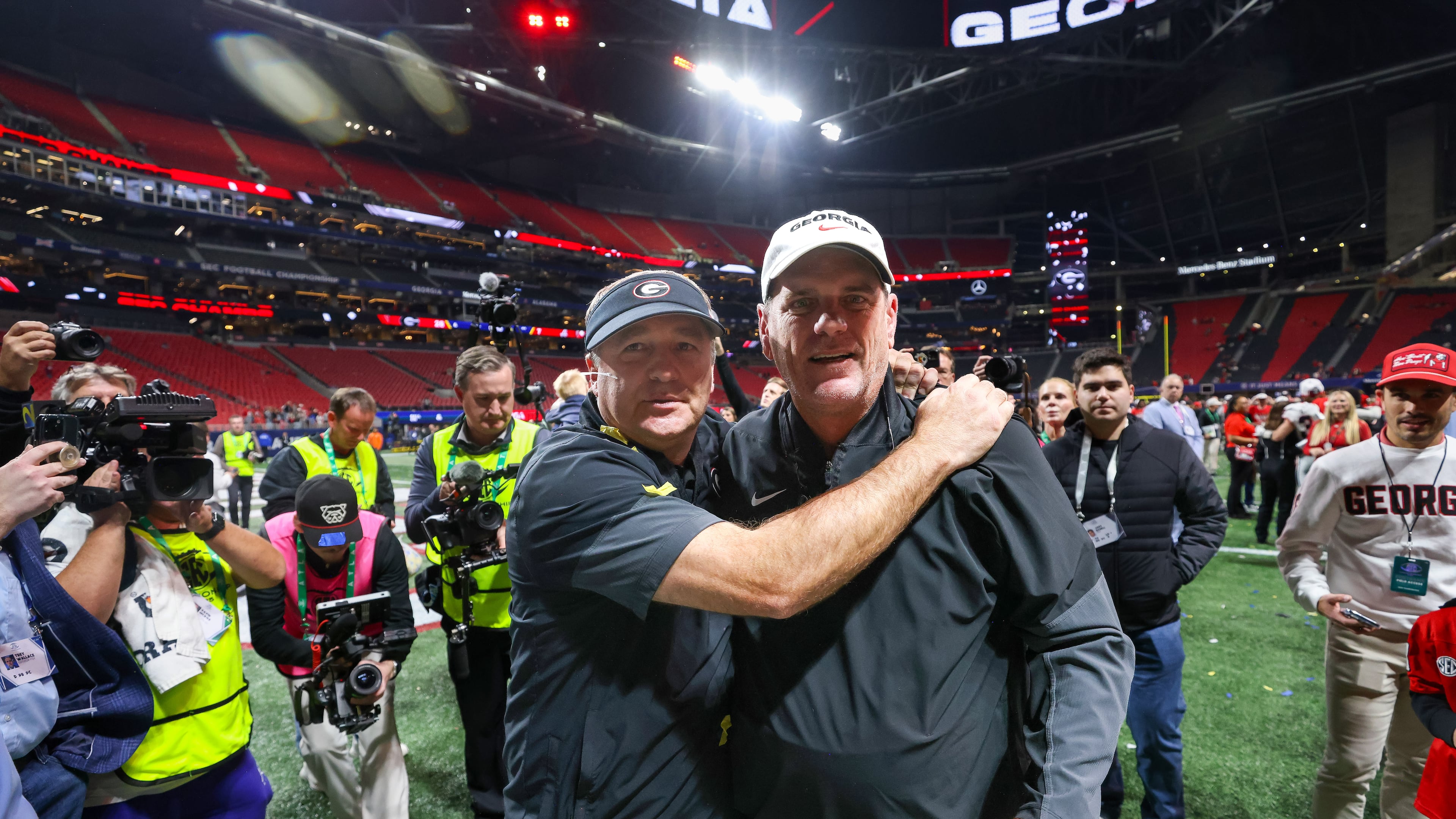 Georgia head coach Kirby Smart (left) celebrates with offensive coordinator Mike Bobo after a 28-7 victory over Alabama in the SEC Championship game at Mercedes-Benz Stadium, Saturday, Dec. 6, 2025, in Atlanta. (Jason Getz/AJC)