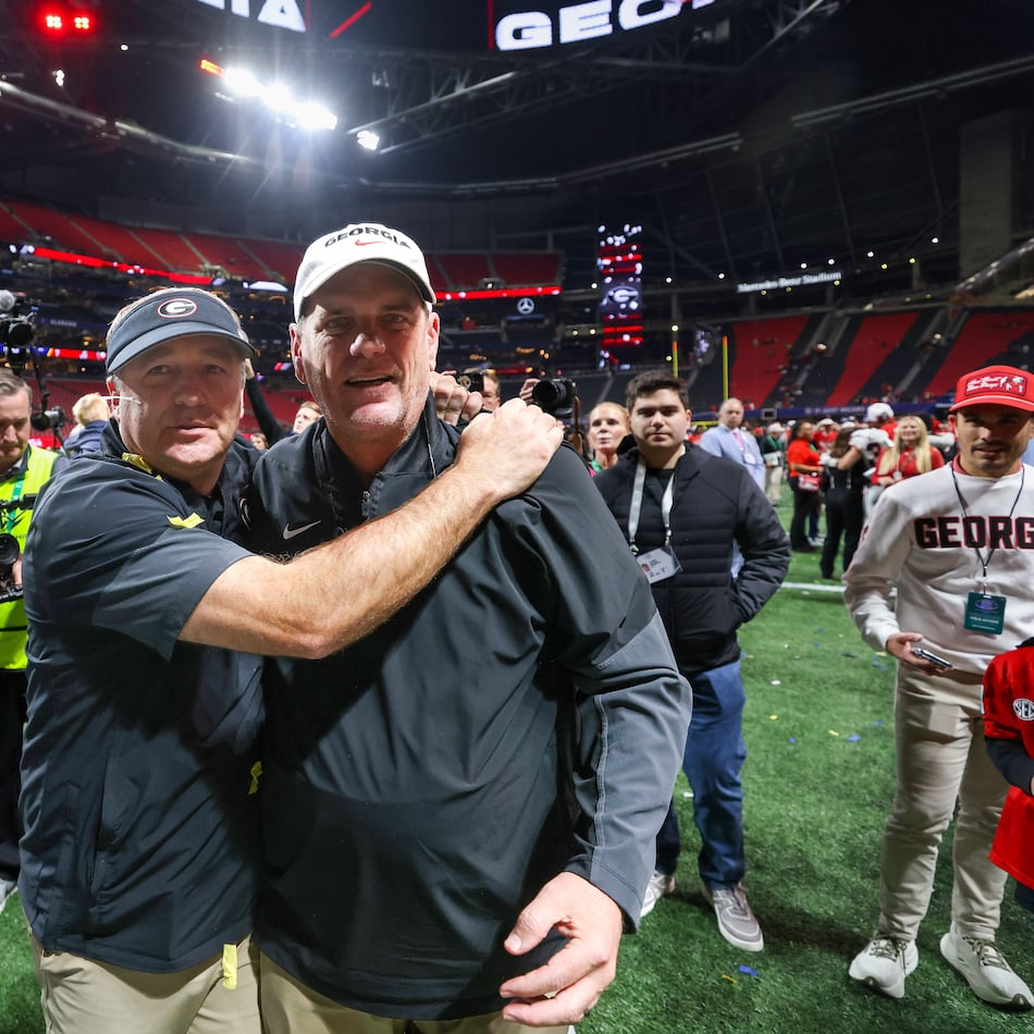 Georgia head coach Kirby Smart (left) celebrates with offensive coordinator Mike Bobo after a 28-7 victory over Alabama in the SEC Championship game at Mercedes-Benz Stadium, Saturday, Dec. 6, 2025, in Atlanta. (Jason Getz/AJC)