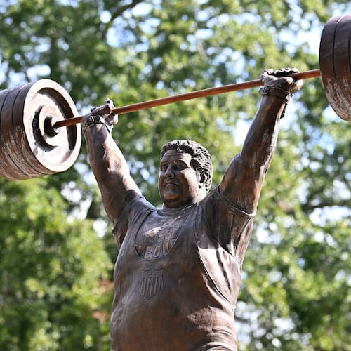 The life-size bronze statue of Paul Anderson in Toccoa, Georgia, took flight after a fourth-grade class wanted to honor "the world's strongest man" in his hometown. (Hyosub Shin/AJC)