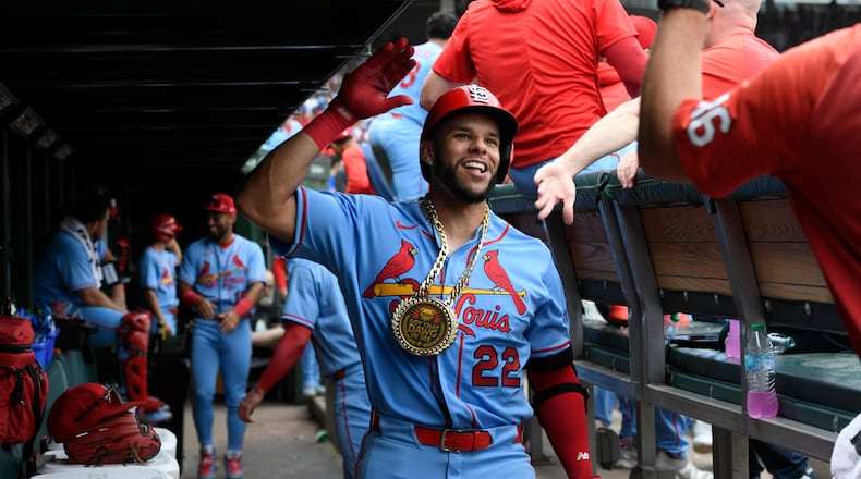 St. Louis Cardinals' Joshua Baez (22) celebrates with teammates in the dugout after hitting a solo home run during the fourth inning of a baseball game against the Chicago Cubs in Chicago, Saturday, Aug. 15, 2026. (AP Photo/Paul Beaty)
