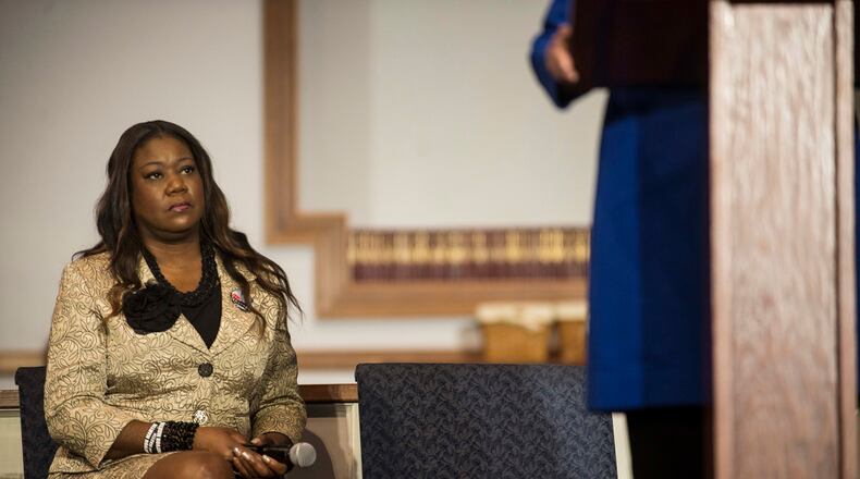 Sybrina Fulton, mother of Trayvon Martin, listens to Hillary Clinton speak at Central Baptist Church in Columbia, S.C., Feb. 23, 2016. Clinton, seeking to cement her lead among black voters, released statements from the mothers of Trayvon Martin and Jordan Davis on Tuesday criticizing Bernie Sanders for saying white people “don’t know what it’s like to be living in a ghetto.”