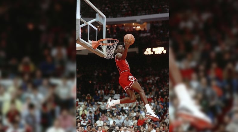 FILE - In this Feb. 6, 1988, file photo, Chicago Bulls' Michael Jordan dunks during the slam-dunk competition of the NBA All-Star weekend in Chicago. (AP Photo/John Swart)