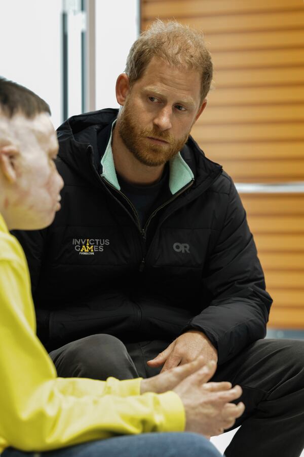 In this photo provided by Superhumans Center, Prince Harry poses with a person who was wounded in war with Russia at the Superhumans Center, an orthopedic clinic in Ukraine, on Thursday, April 10, 2025. (Yana Stukach/Superhumans Center via AP)