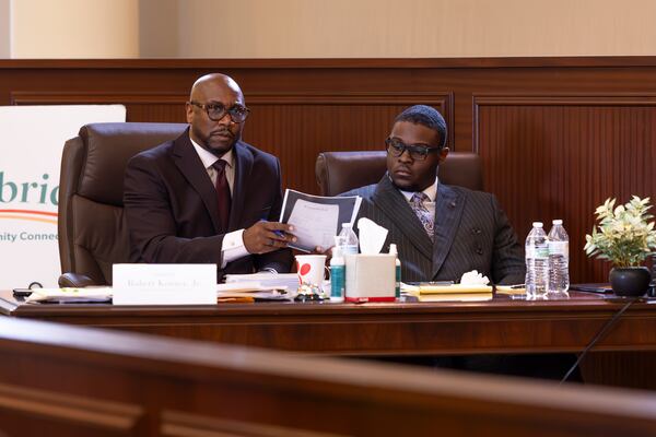 Attorney Robert Kenner Jr. passes Mayor Jayden Williams evidence papers during an investigative hearing for Mayor Williams on Saturday, September 12, 2026 at Stockbridge City Hall. (Frankie Cole for the AJC)