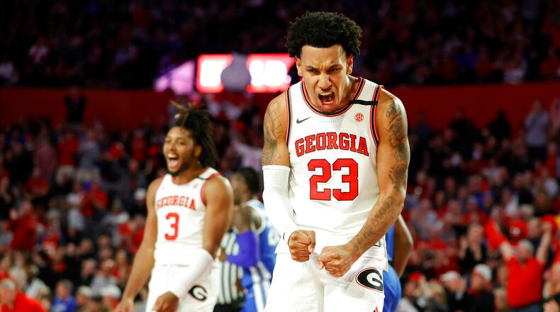 Georgia's Braelen Bridges, right, and Kario Oquendo celebrate during the first half of an NCAA college basketball game against Kentucky, Saturday, Feb. 11, 2023, in Athens, Ga. (AP Photo/Alex Slitz)