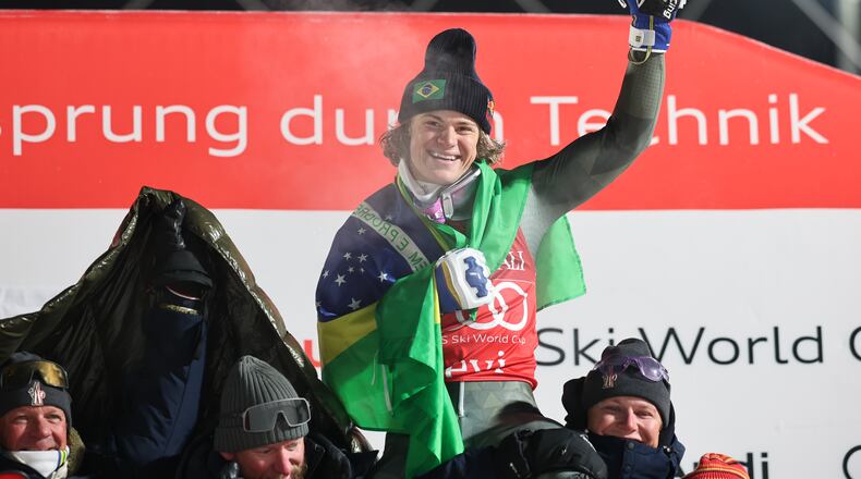 Brazil's Lucas Pinheiro Braathen celebrates with the Brazilian team after winning an alpine ski, men's World Cup slalom, in Levi, Finland, Sunday, Nov. 16, 2025. (AP Photo/Marco Trovati)